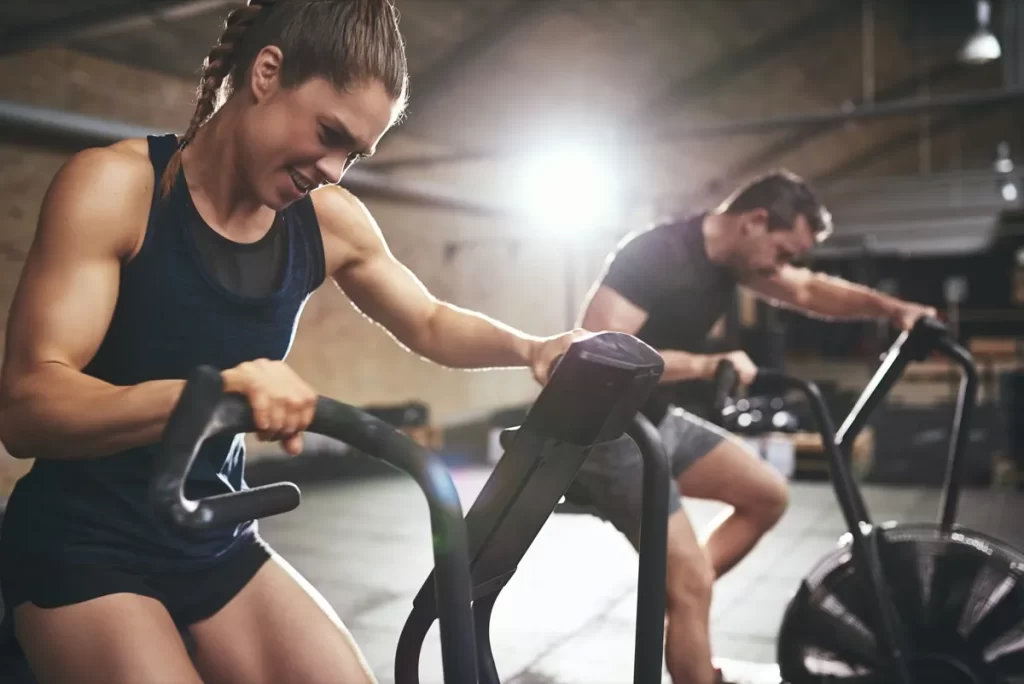 Man and Women Doing Cardiovascular Exercise in a GYM
